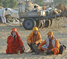 Indian holy men at Pushkar Fair Rajasthan photograph by Raphael Shevelev